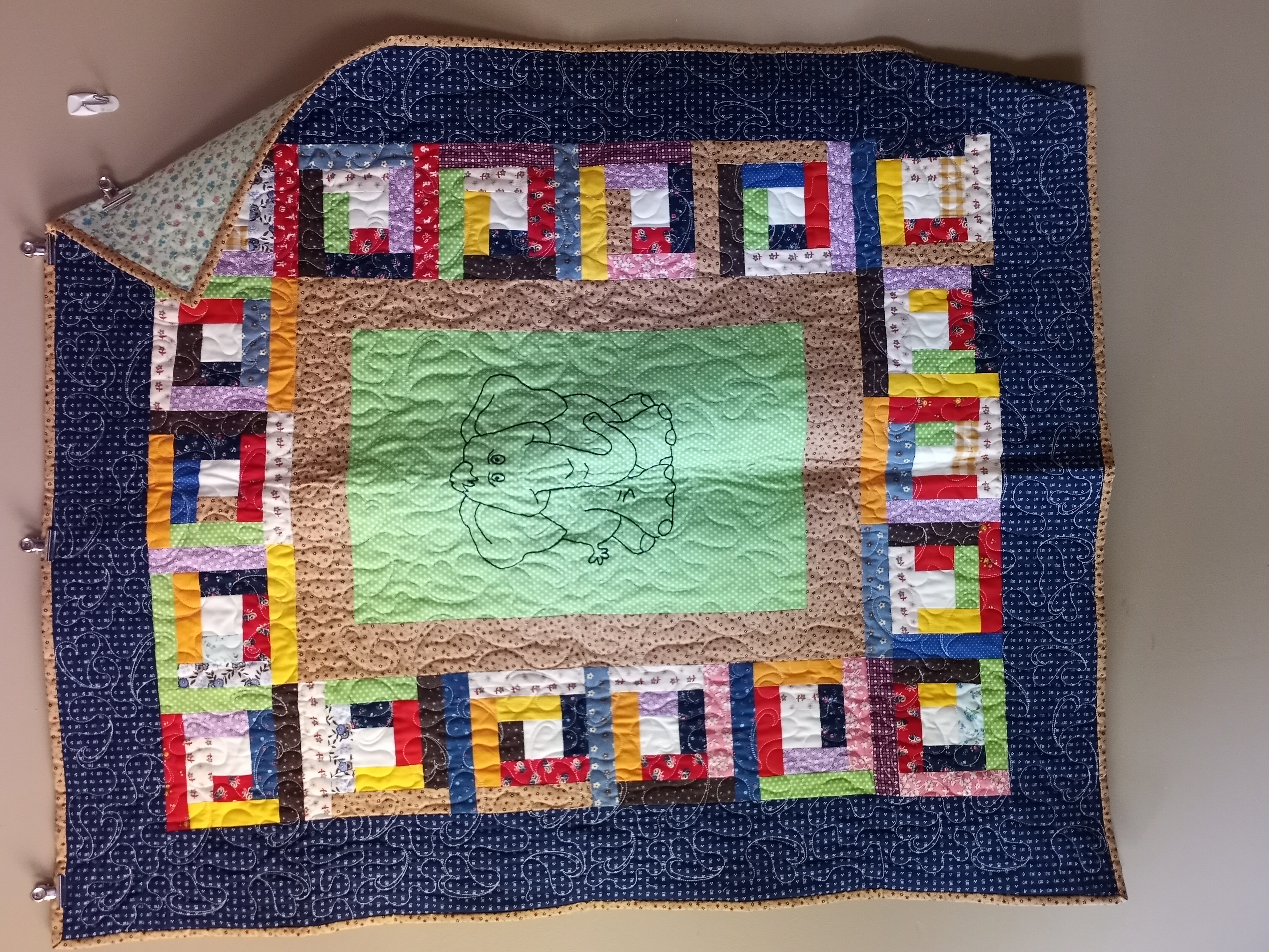 Colorful elephant quilt with geometric border